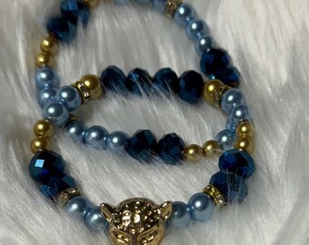 Light blue and gold charmed jaguar bracelet