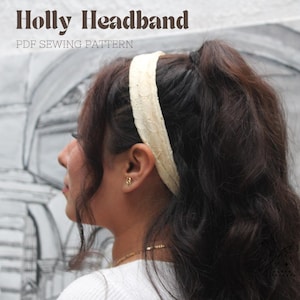 May include: A white lace headband worn by a person with long brown hair. The headband is a simple design with a subtle texture. The image is titled "Holly Headband PDF Sewing Pattern".
