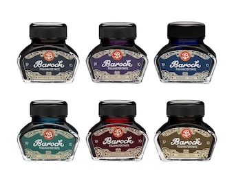 May include: Six glass bottles of Barock fountain pen ink, each with a black screw cap and a 30ml capacity. The labels feature the brand name, the color name, and decorative scrollwork. The colors include anthrazit, kaviar, marine, jade, bordeaux, and umbra.