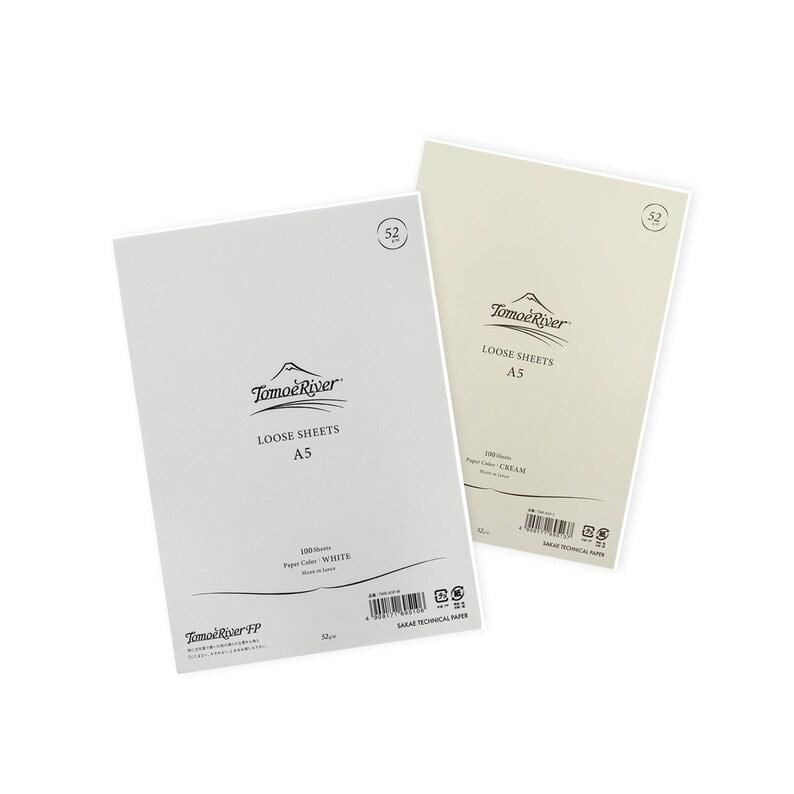 May include: Two packs of Tomoe River loose sheets paper, one white and one cream. Both packs are A5 size and feature the Tomoe River logo. The white pack says "100 sheets, Paper Color: WHITE, Made in Japan" and the cream pack says "100 sheets, Paper Color: CREAM, Made in Japan".