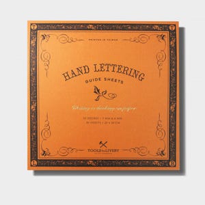 May include: Orange guide sheets for hand lettering with a black border and gold lettering. The text on the sheet reads "Hand Lettering Guide Sheets" and "Writing is thinking in ink." The sheet also includes the details "52 Degree / 3 MM & 6 MM, 80 Sheets / 20 x 20 CM" and "Tools to Liveby."