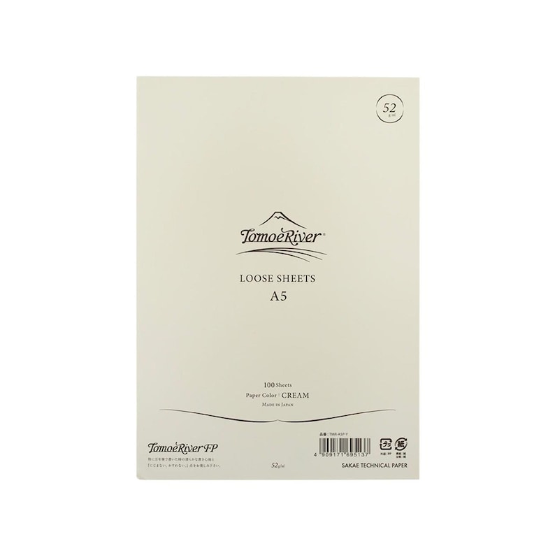 May include: A pack of 100 loose sheets of cream-colored paper from Tomoe River. The paper is A5 size and is made in Japan. The pack has the text "Tomoe River FP" and "SAKAE TECHNICAL PAPER" printed on it.