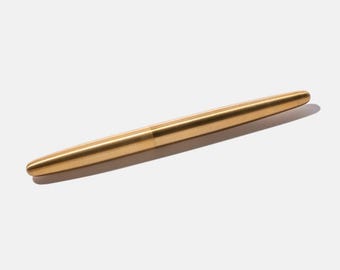 May include: A gold-colored metal pen with a smooth, cylindrical design.