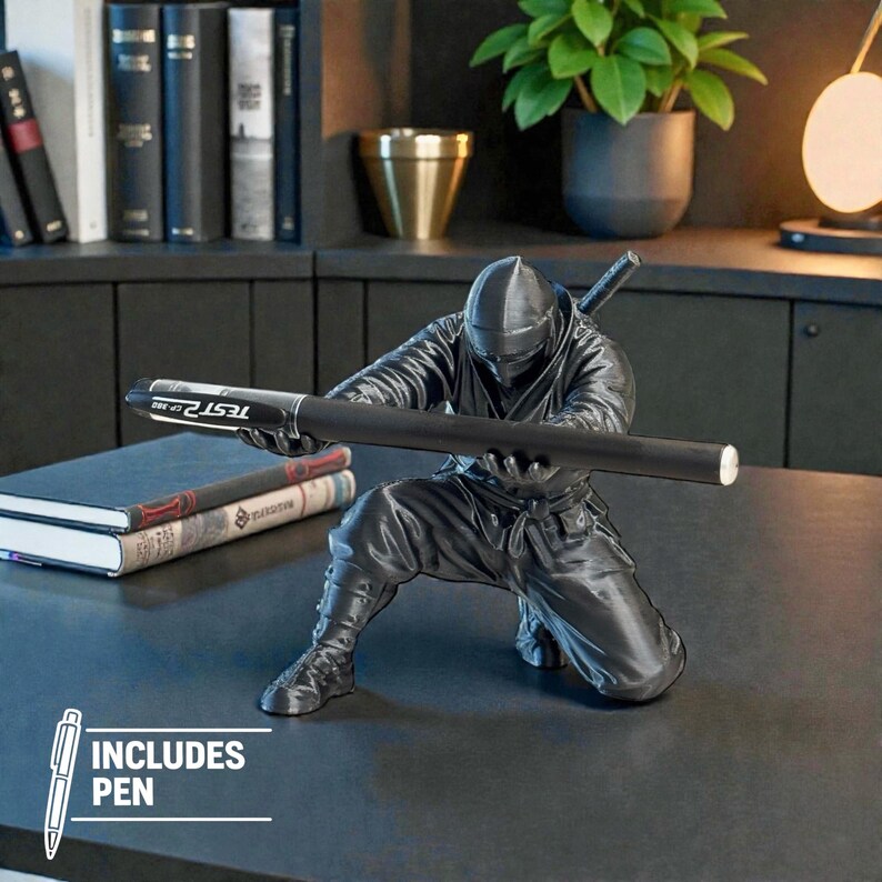 May include: A black ninja figurine holding a black pen with the text "TEST OF TIME". The figurine is kneeling and has a sword on its back. The image includes a pen.