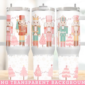 May include: White insulated tumbler featuring a festive design with nutcrackers and pink Christmas trees. The tumbler has a silver lid and handle. The design includes the text "PNG TRANSPARENT BACKGROUND" at the bottom.