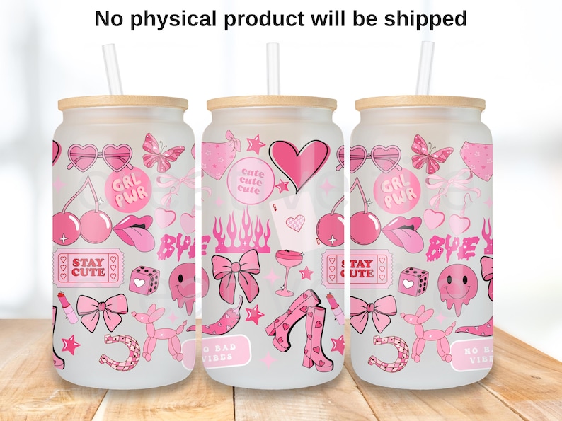 May include: Three glass can-shaped tumblers with bamboo lids and straws. Each tumbler is decorated with pink graphics including hearts, cherries, bows, and the words "GRL PWR" and "STAY CUTE". The tumblers are on a wooden surface.