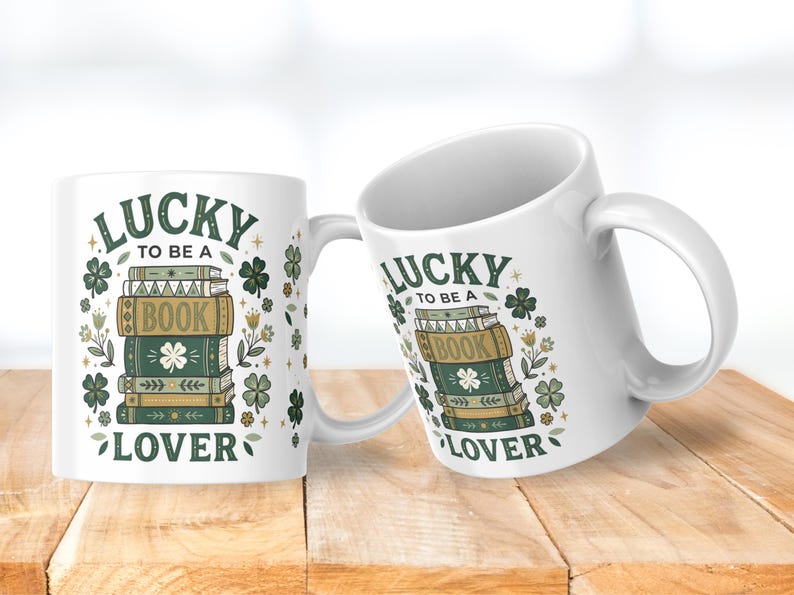 May include: Two white ceramic mugs with the text "LUCKY TO BE A BOOK LOVER" and a stack of books with shamrock and floral designs. The mugs are on a wooden surface.