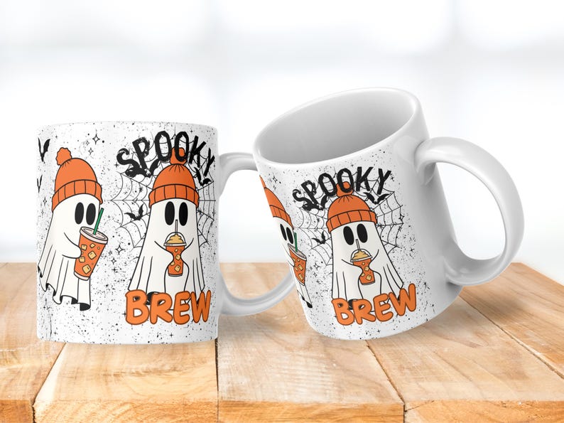 May include: White ceramic mug with a Halloween-themed design. The mug features a cartoon ghost wearing an orange beanie and holding a drink. The words "Spooky Brew" are printed on the mug, along with a spiderweb and bats.