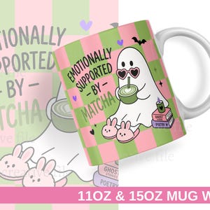 May include: A white ceramic mug featuring a green and pink checkered pattern. The design includes a white ghost wearing heart-shaped sunglasses and bunny slippers, holding a matcha drink. Text reads EMOTIONALLY SUPPORTED BY MATCHA, GHOST STORIES, and POETRY.