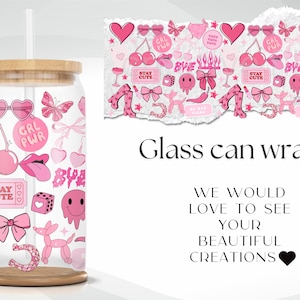 May include: A glass can wrap with a pink and white design. The wrap features various illustrations, including cherries, hearts, bows, and the text "GRL PWR" and "STAY CUTE". The can has a wooden base and a bamboo lid.