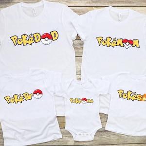 May include: White t-shirts with a Pokemon theme. The shirts say "PokéDad", "PokéMom", "PokéBro", "PokéOne", and "PokéSis".