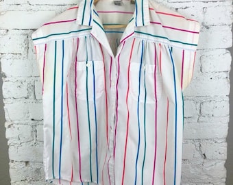 May include: A white button-down shirt with colorful vertical stripes. The shirt has short sleeves and a collared neckline.