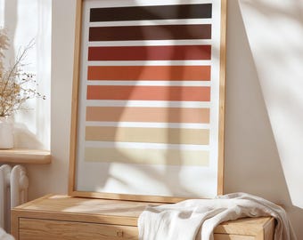 May include: A framed print with a gradient of colors from dark brown to light beige. The print is made up of 10 horizontal stripes of color, each a slightly different shade than the one above it. The print is in a light wood frame.