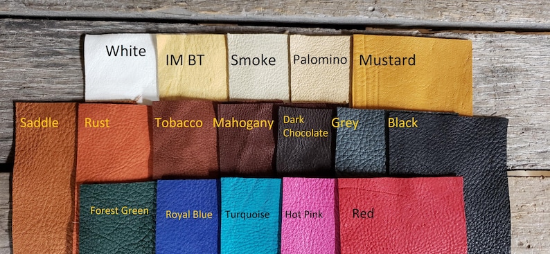 May include: A selection of leather swatches in various colours, including white, rust, tobacco, mahogany, dark chocolate, grey, black, forest green, royal blue, turquoise, hot pink, and red. The swatches are arranged in three rows.