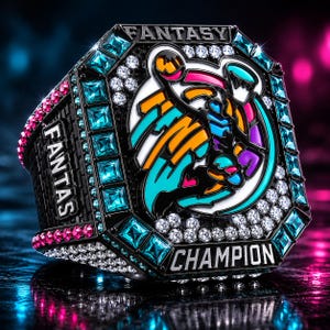 May include: A black octagonal ring with the word "FANTASY" on the side and top. The ring features a colorful graphic and the word "CHAMPION". It is adorned with blue, pink, and white gemstones.