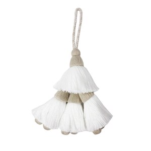May include: A decorative tassel featuring a tiered design with three white fibre sections. Each section is topped with a light beige, wrapped thread cap. A matching beige and white twisted cord loop extends from the top for hanging purposes.