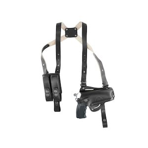 May include: Black leather shoulder holster with a magazine pouch and a pistol holster. The holster has adjustable straps and a snap closure.