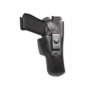 May include: Black leather holster with a black handgun. The holster has a metal clip and a strap. The handgun is partially visible, with the grip and slide exposed. The background is white.