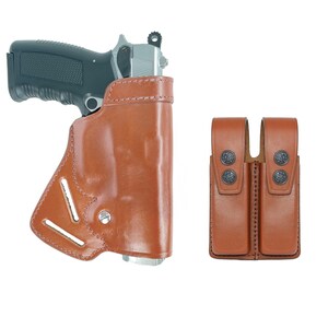 May include: A brown leather holster for a handgun with a double magazine pouch. The holster has a belt loop and a snap closure. The magazine pouch has two snaps.