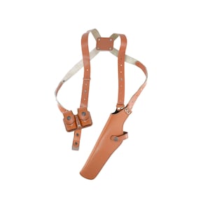 May include: A brown leather shoulder holster with a magazine pouch and a holster for a handgun.