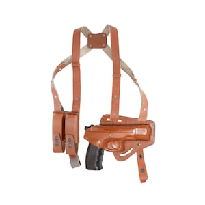 May include: A brown leather shoulder holster with a magazine pouch and a pistol. The holster has adjustable straps and a snap closure.