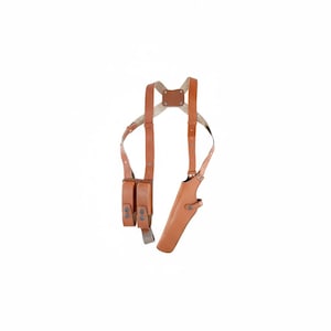 May include: A brown leather shoulder holster with two magazine pouches and a pistol holster. The holster has adjustable straps and a leather back piece. The leather is a light brown color.