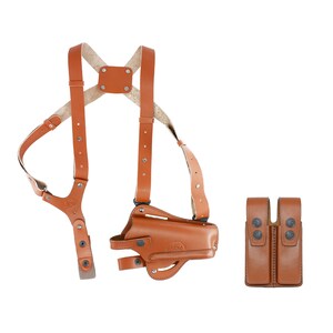 May include: A brown leather shoulder holster with a magazine pouch. The holster has a strap that goes over the shoulder and a strap that goes around the waist. The magazine pouch has two slots for magazines.