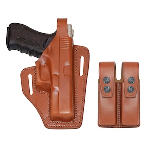 May include: A brown leather holster for a handgun with a double magazine pouch. The holster has a belt loop and a snap closure. The magazine pouch has two slots for magazines.