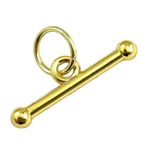 May include: A gold-toned toggle clasp component consisting of a smooth, cylindrical bar with spherical ends and a circular jump ring attached to the center. The metal surface is polished and reflective, showing a bright yellow gold color throughout.