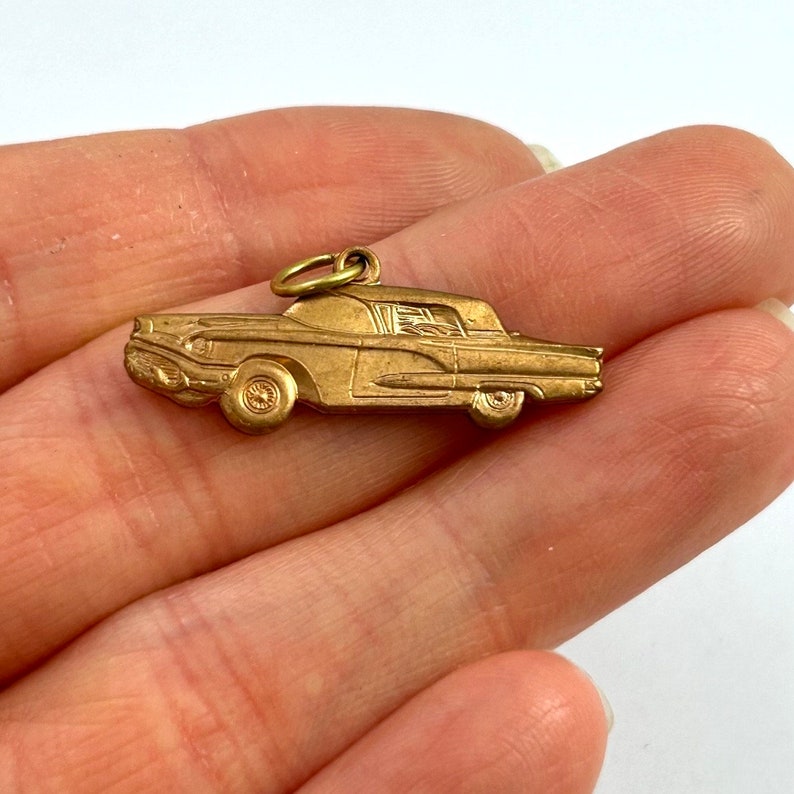 Puede incluir: Encanto de metal dorado en forma de coche antiguo. El encanto est&aacute; detallado con un parabrisas, faros y ruedas.