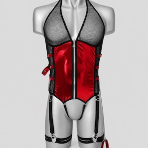 May include: A sleeveless bodysuit featuring a black mesh halter top and a metallic red front panel with a central zipper. The garment includes black side straps with buckles, attached garter straps with metal rings, and a dangling chain with a cuff.