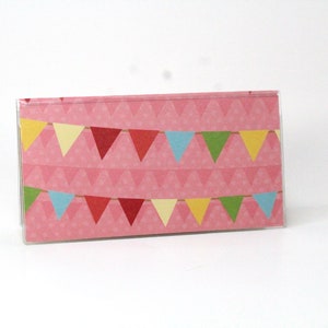 May include: A pink card with a pattern of small white triangles and a string of colorful triangle flags.