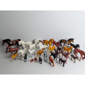 Lot med 28 vintage hästfigurer i plast, blandade storlekar + nyckelringar med datum från 90-talet