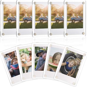 May include: A set of ten clear acrylic magnetic photo frames, each featuring four silver-toned metal corner fasteners. These rectangular frames are designed to hold photographs securely between two transparent panels for a floating display effect.