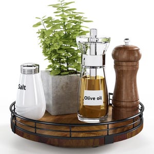 May include: A round wooden serving tray with a black metal rim. The tray has a salt shaker, an olive oil dispenser, a pepper grinder, and a small potted plant on it.