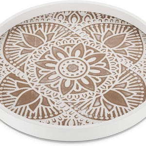 May include: White round tray with a brown mandala design. The tray has a raised rim and is perfect for serving snacks or drinks.