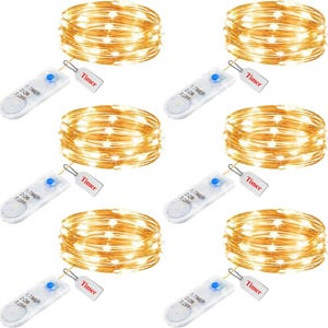 May include: Six sets of warm white LED string lights, each coiled and paired with a timer control. The timers are white with a blue button and a small tag that says "Timer". The lights are ideal for decorative use.