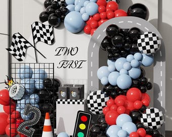 May include: A festive racing-themed party decoration set. Includes black and white checkered flags, balloons in black, red, and light blue, a road-shaped arch, and a traffic light. The text "TWO FAST" is also visible.