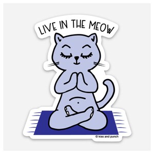 May include: A sticker featuring a light purple cat in a yoga pose on a blue mat. The cat has closed eyes and is in a meditative pose with its paws together. The text "LIVE IN THE MEOW" is above the cat.
