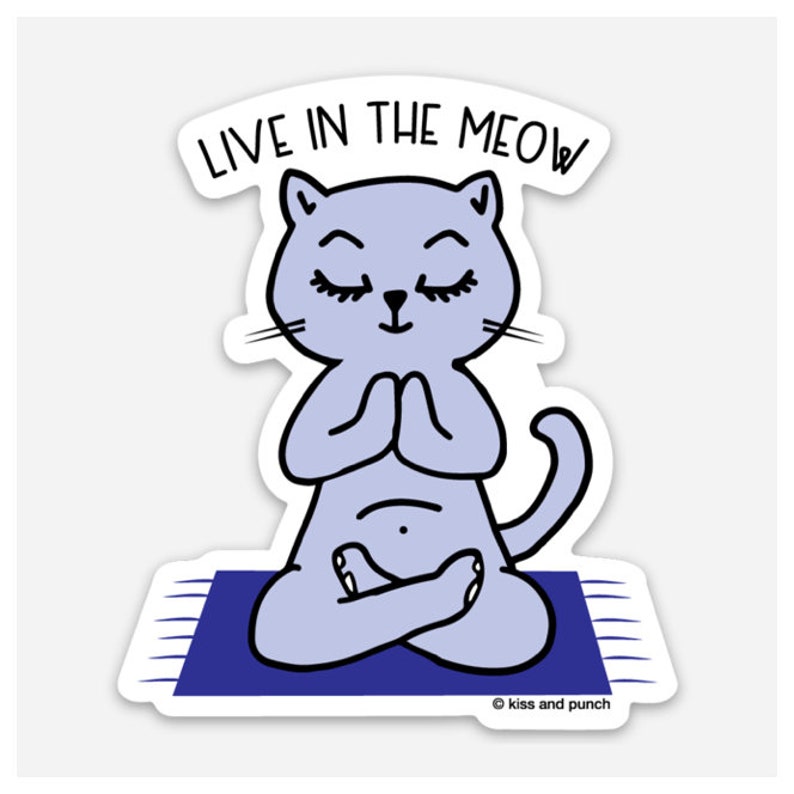 May include: A sticker featuring a light purple cat in a yoga pose on a blue mat. The cat has closed eyes and is in a meditative pose with its paws together. The text "LIVE IN THE MEOW" is above the cat.