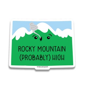 May include: A rectangular sticker with a green mountain design, blue sky, and white clouds. The text "ROCKY MOUNTAIN (PROBABLY) HIGH" is in black. The sticker has a white border and the words "kiss and punch" at the bottom.