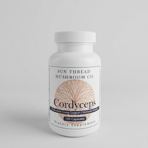 May include: A white plastic bottle of Cordyceps capsules. The label features the text "SUN THREAD MUSHROOM CO." and "Cordyceps" with the words "Endurance | Lung Support | Immune Health" below. The bottle contains 120 capsules and is a dietary supplement.