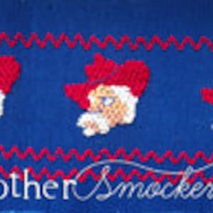 May include: Three embroidered Santa Claus faces with red hats on a blue background. The background has a red zig-zag pattern. The text "Mother Smocker" is at the bottom of the image.