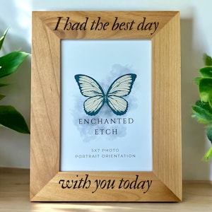 May include: A wooden picture frame with the text "I had the best day with you today" engraved on it. The frame has a 5x7 photo opening and a butterfly image inside. The text "Enchanted Etch" is also visible.