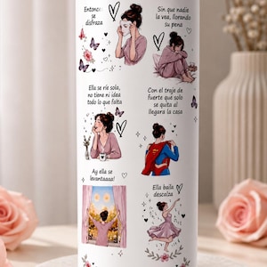 May include: A white stainless steel tumbler featuring illustrations of a woman in various poses, with text in Spanish. The design includes butterflies, hearts, and floral accents, creating a motivational theme.
