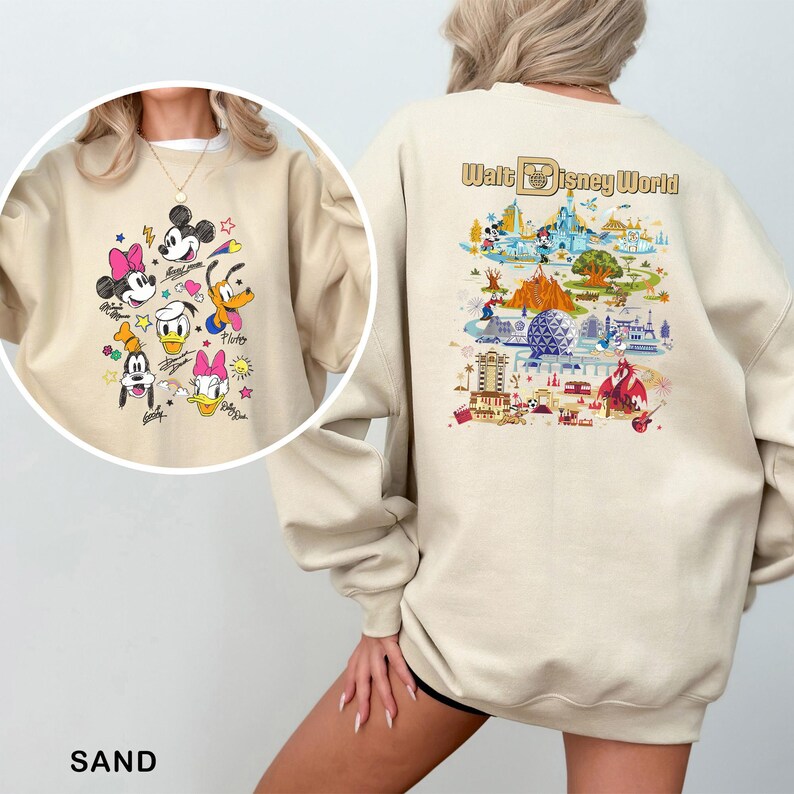 May include: Sand-coloured sweatshirt with a colourful graphic of Disney characters on the front and a Walt Disney World map design on the back. The front design includes Mickey Mouse, Minnie Mouse, Donald Duck, Daisy Duck, Goofy, and Pluto. The back design features park landmarks.