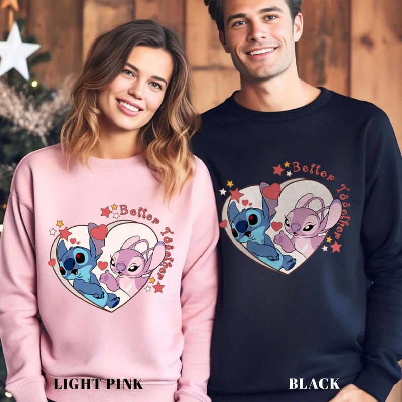 May include: Two matching sweatshirts with a heart design featuring Stitch and Angel from Lilo & Stitch. The text "Better Together" is printed on the heart. One sweatshirt is light pink and the other is black.