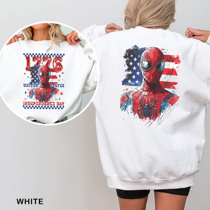 May include: A white long-sleeve sweatshirt featuring a graphic of a red and blue superhero mask over an American flag background. The front design includes the text 1776 UNITED STATES INDEPENDENCE DAY with a checkered border and red stars.
