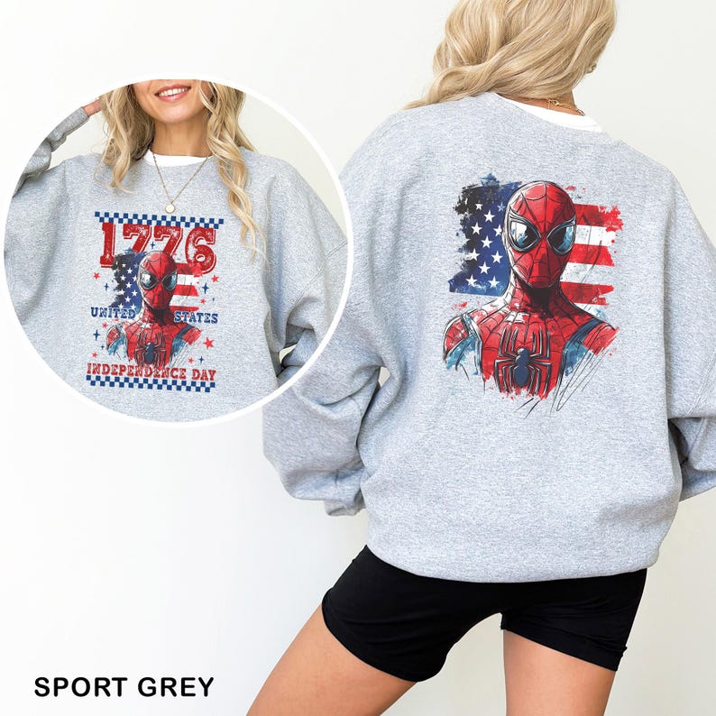May include: A light grey crewneck sweatshirt featuring a graphic of the superhero Spider-Man centred on the back, layered over a distressed American flag design. The front includes the same graphic with the text 1776 UNITED STATES INDEPENDENCE DAY.