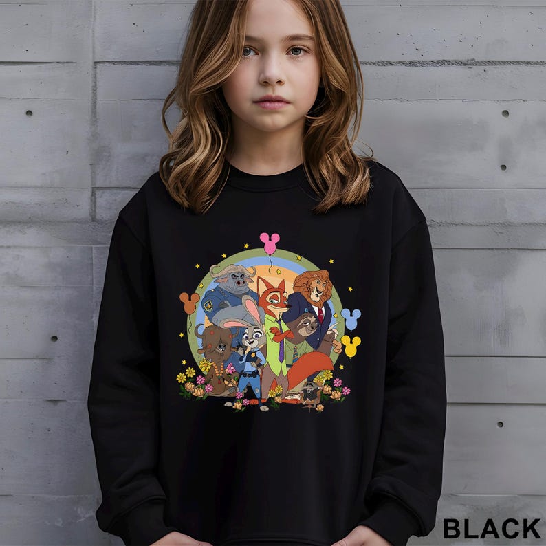 May include: Black crewneck sweatshirt featuring a colorful graphic of animated animal characters. The design includes a fox, lion, bunny, and other characters, with floral and Mickey Mouse-themed accents. The word "BLACK" is printed at the bottom right.